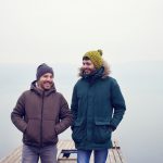 Two men smiling